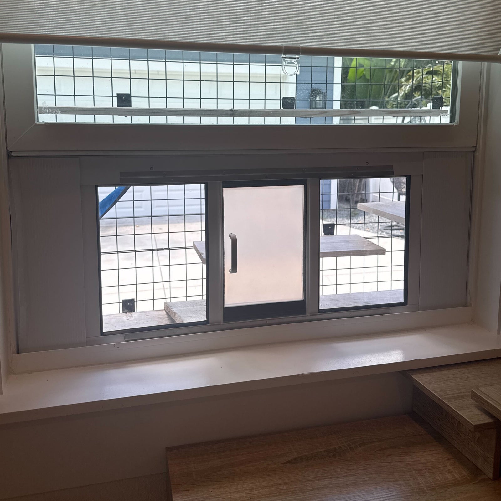 Adjustable cat door window insert installed into window